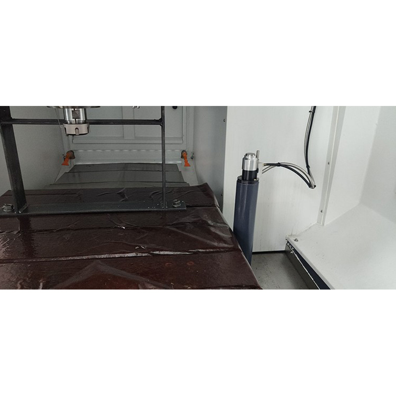 Close-up view of the DC6060A five-axis CNC machine in operation at a shoe mold factory, showing precise cutting action on a rubber sole mold.