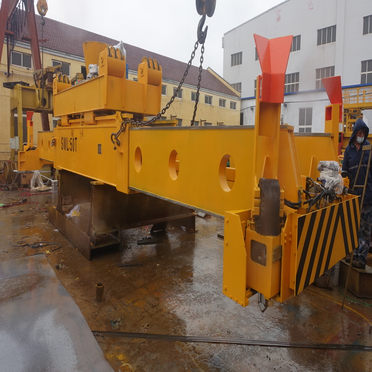 Technician performing maintenance on Taiding container spreader hydraulic system