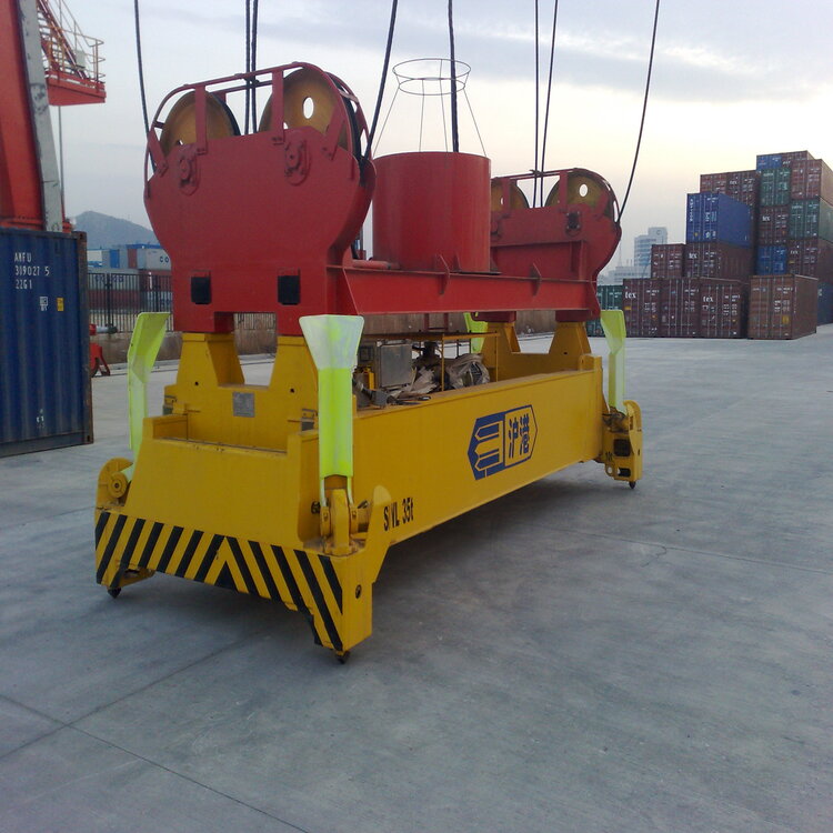 Taiding Heavy Industry container spreader adjusting to different container sizes at a busy port terminal
