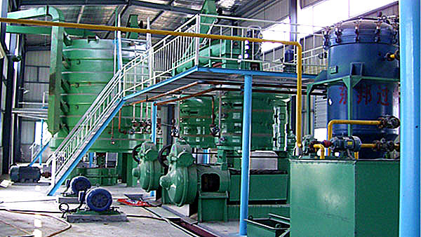 Modern soybean oil processing line showing automated conveyor belts and precision equipment in a clean industrial setting.