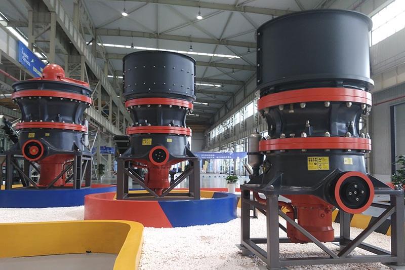 Workers cleaning the cavity of a short-head cone crusher
