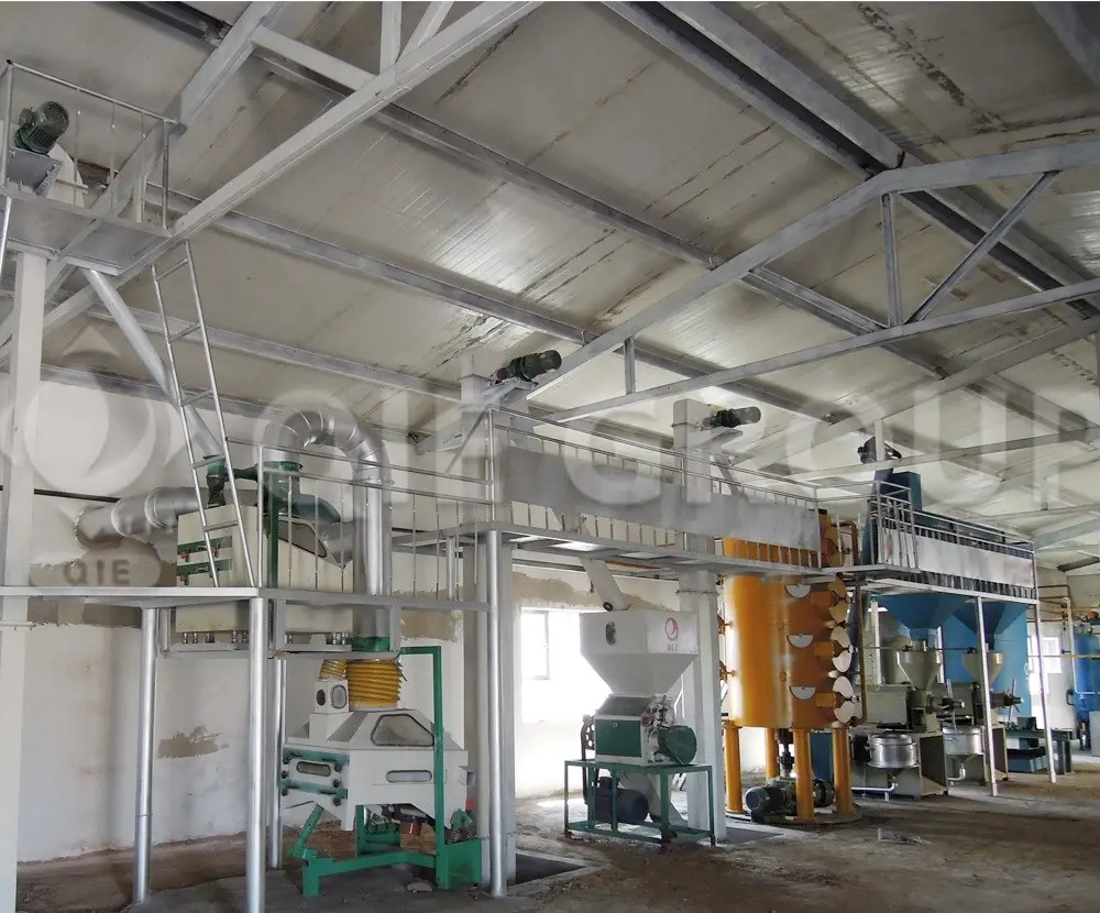 Sunflower seed preprocessing equipment in modern oil processing workshop, including cleaning, dehulling, and flaking machines
