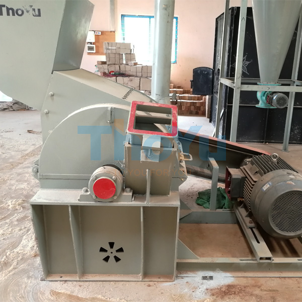 A technician troubleshooting a jammed bamboo straw crusher