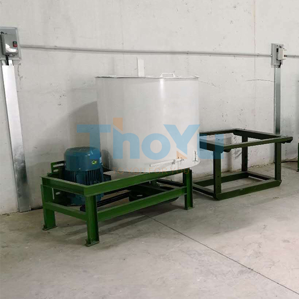 Factory floor with workers monitoring automated plastic pallet machines and recycling bins labeled 'Recycled Material Input'