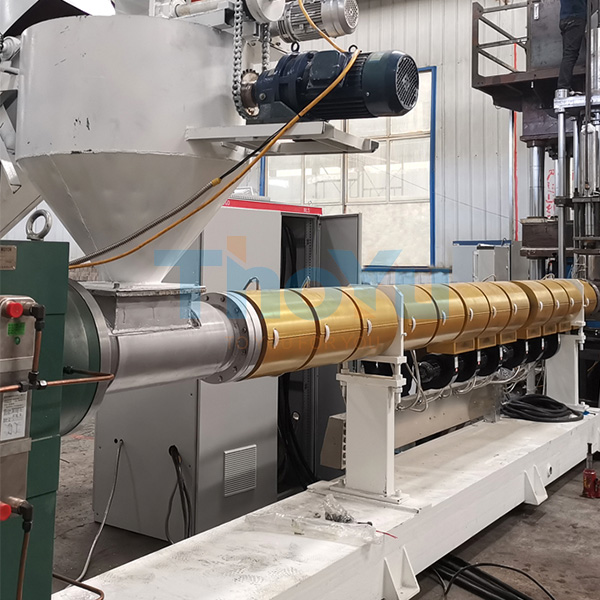 Plastic pallet machine in operation at a recycling facility, showing automatic feeding and molding process
