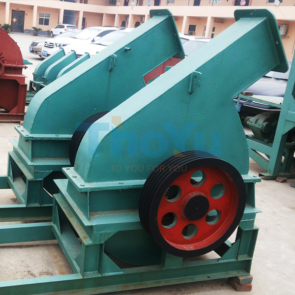 Industrial factory floor showing multiple drum wood chippers integrated in pallet production line
