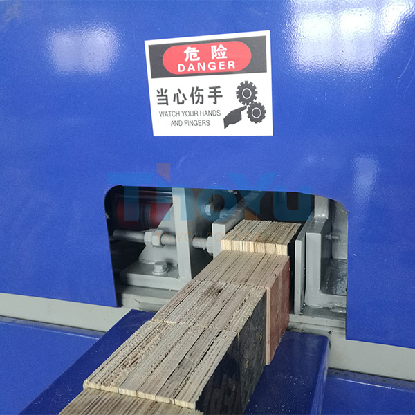 Operator adjusting settings on the touchscreen interface of the pallet leg nailing machine