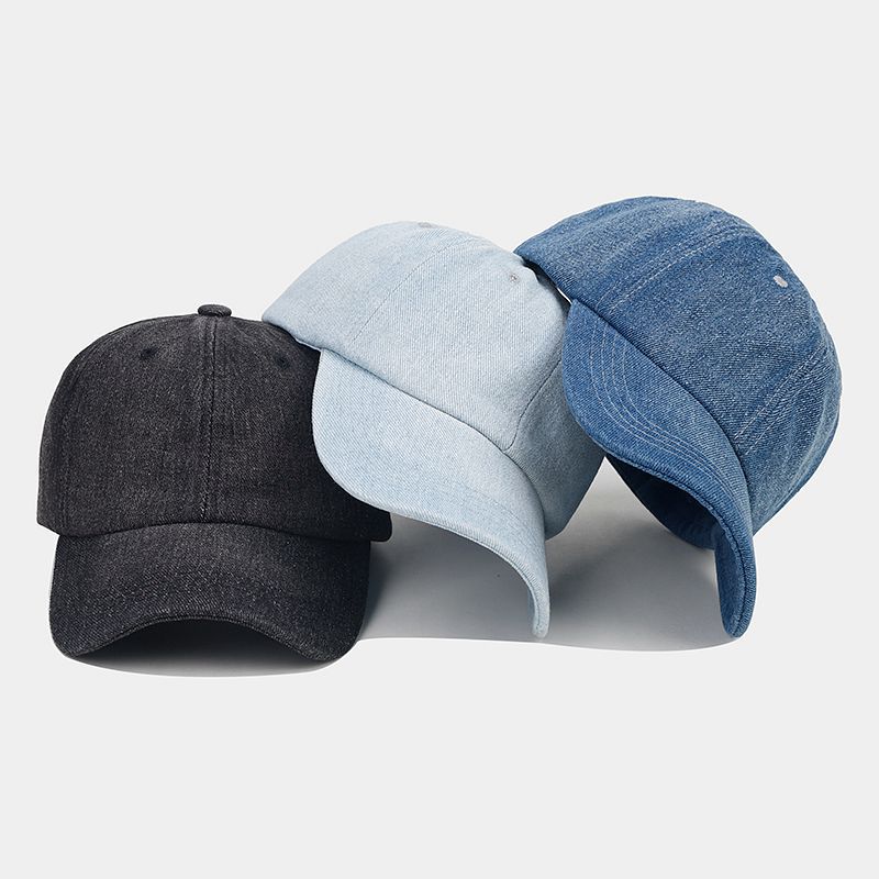 A group of diverse people wearing matching denim baseball caps during an outdoor event, highlighting how the hat enhances team unity and brand visibility